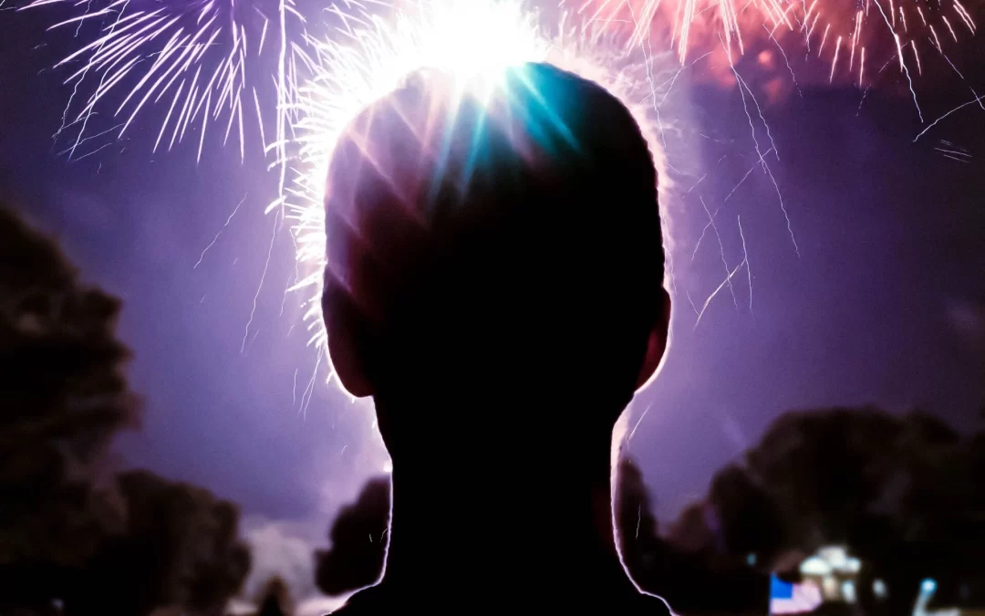 spenser-sembrat-man-in-foreground-looking-at-fireworks-display-unsplash-scaled