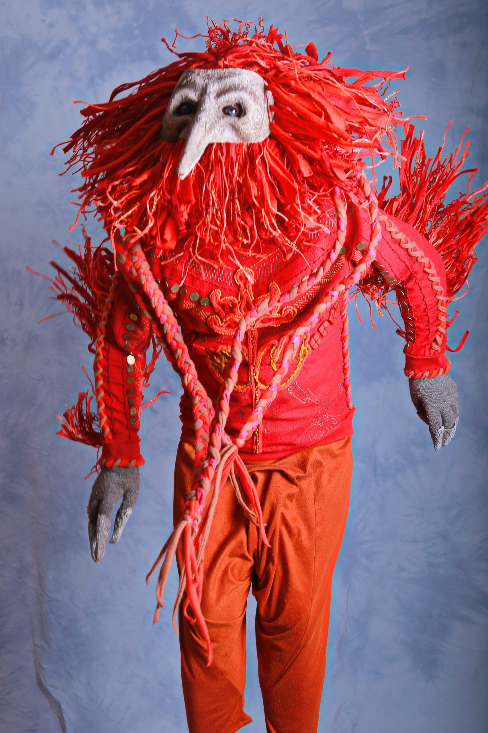-Shaman in bird mask and redshirt orange pants- by Hrustall photographer on Unsplash