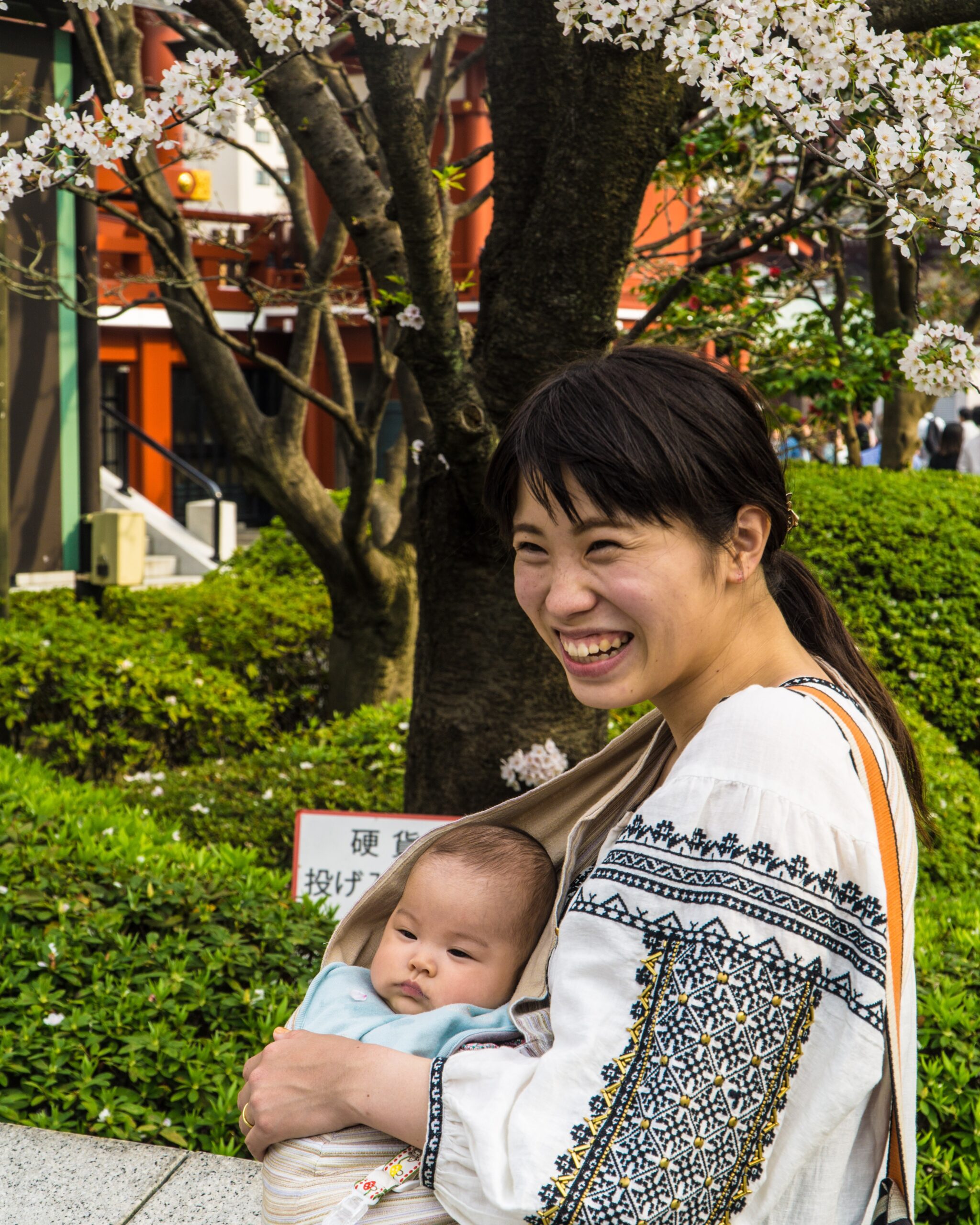 guille-alvarez-Woman holding baby in harnessunsplash