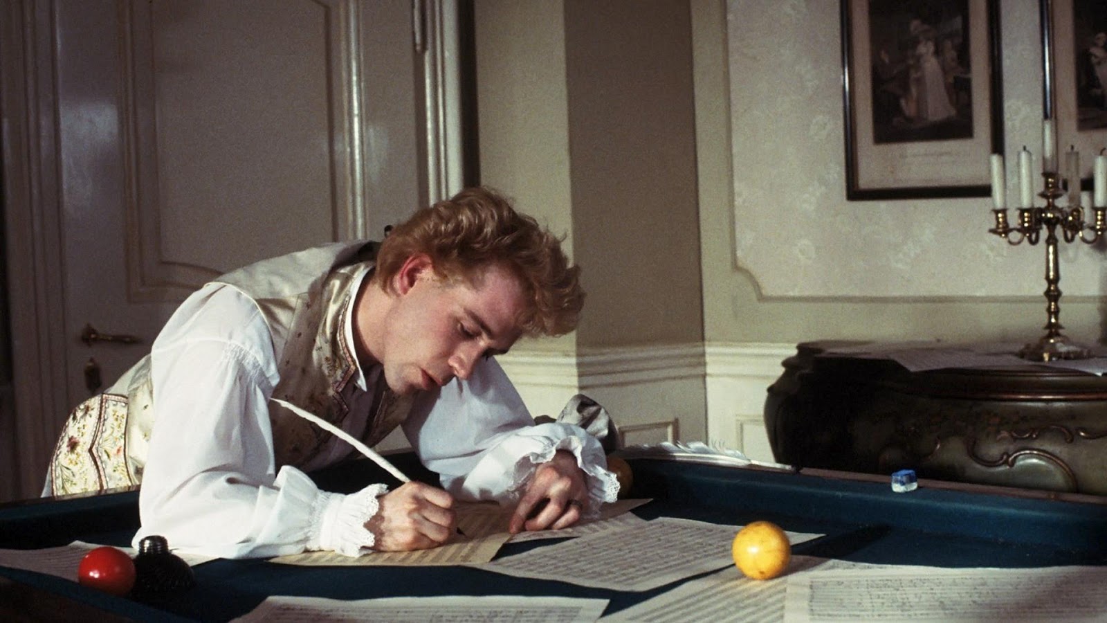 Amadeus Movie showing Hulce as Mozart composing on a pool table.