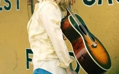 Kelly Willis with Guitar slung over back