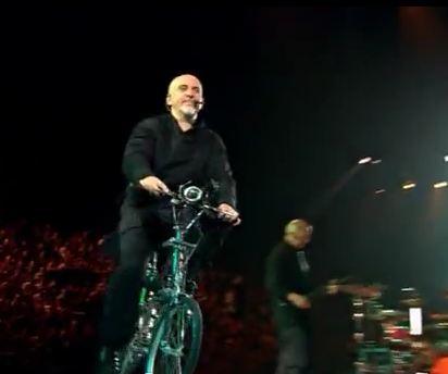 Peter Gabriel riding bicycle on round stage 2006