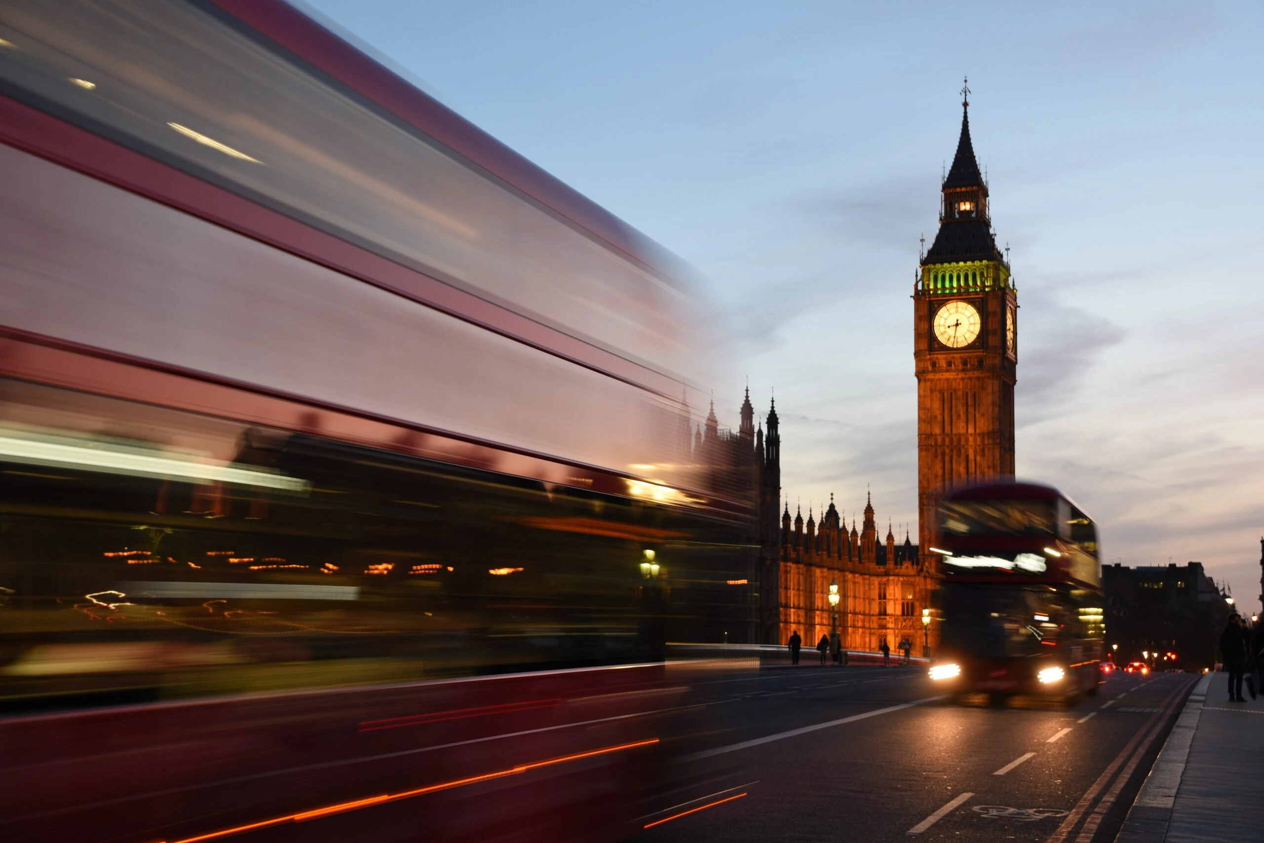 david-dibert-Double decker bus whizzing by with Big Ben in background London UK-unsplash-scaled