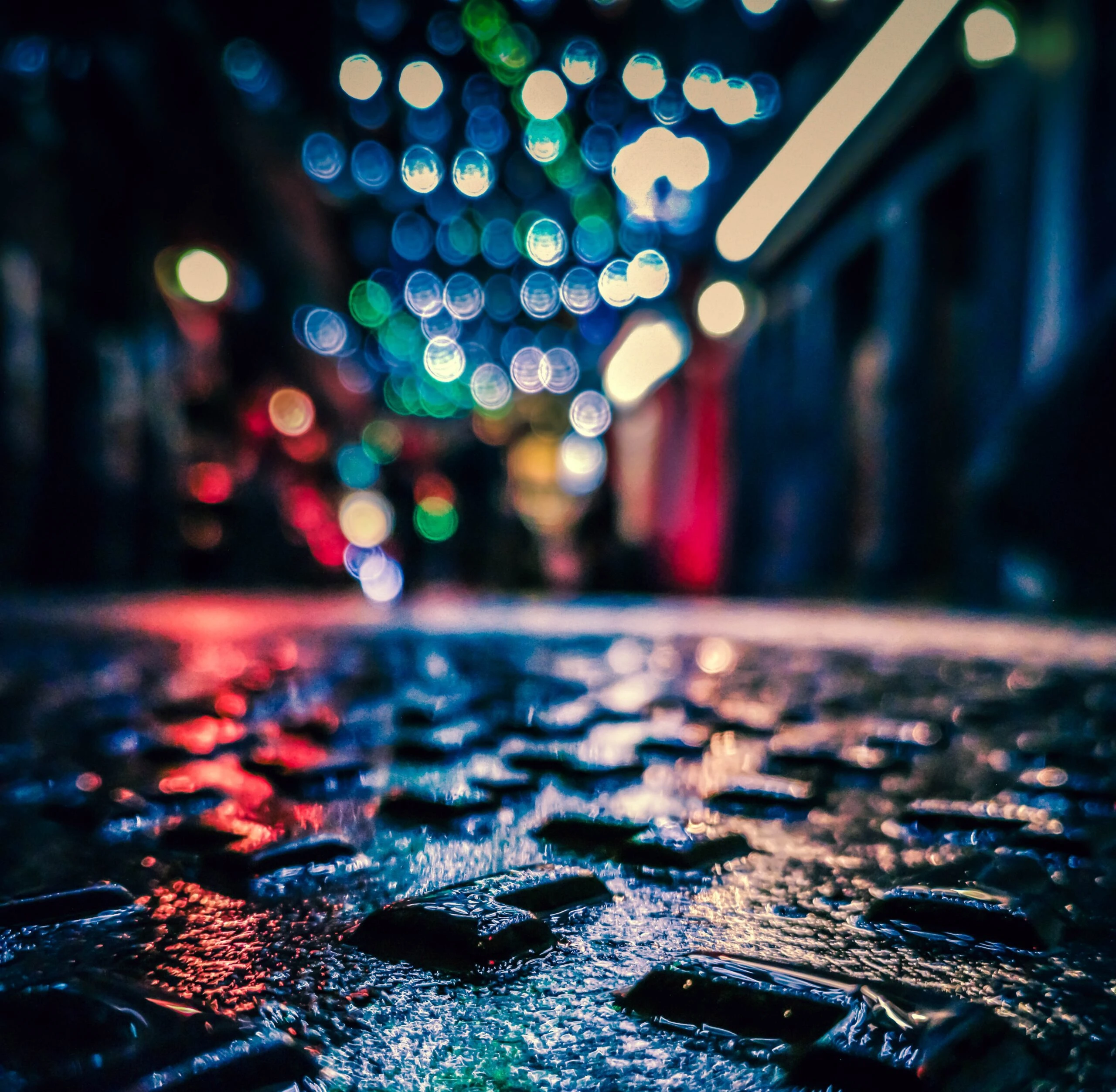enric-moreu-Wet Dublin Ireland city street with lights reflecting from surrounding business-unsplash