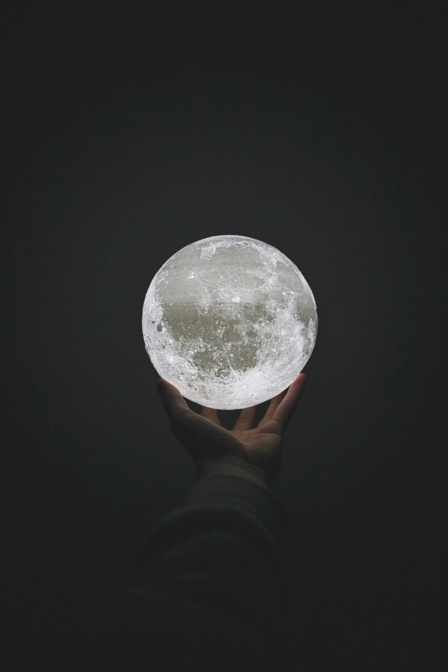 asper-benning-Moon in extended hand-unsplash-scaled