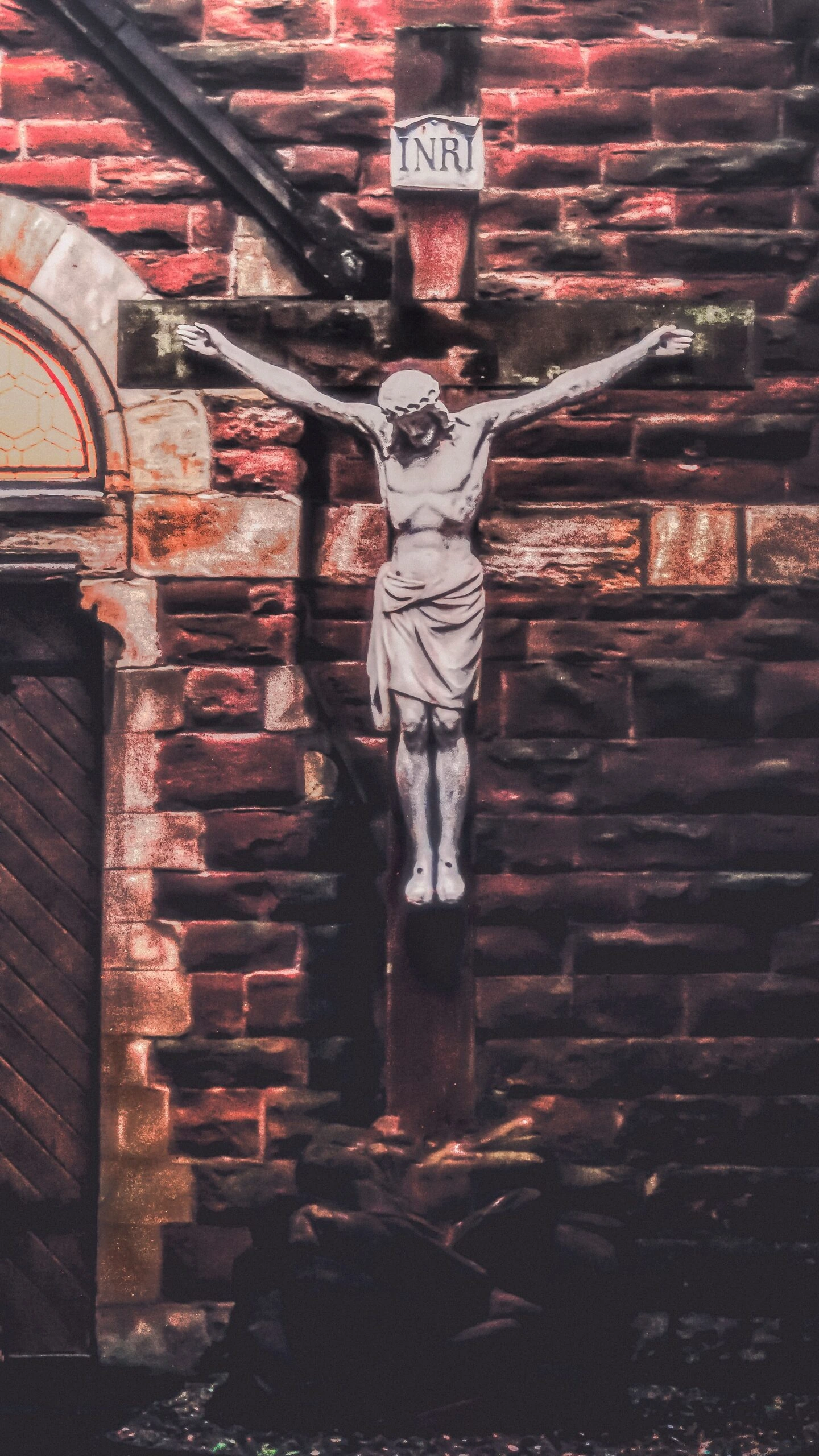 Jesus on the Cross stattue on side of Belfast Ireland Church by K Mitch Hodge Unsplash
