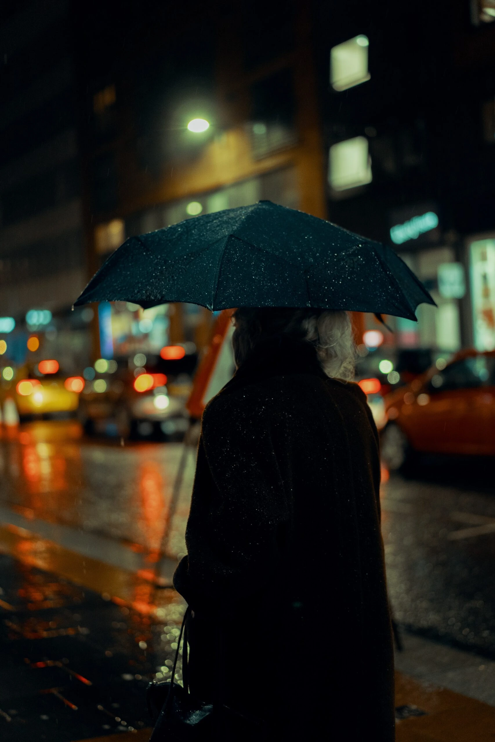 ross-sneddon-man with black umbrella in the rain NYC-unsplash (1)