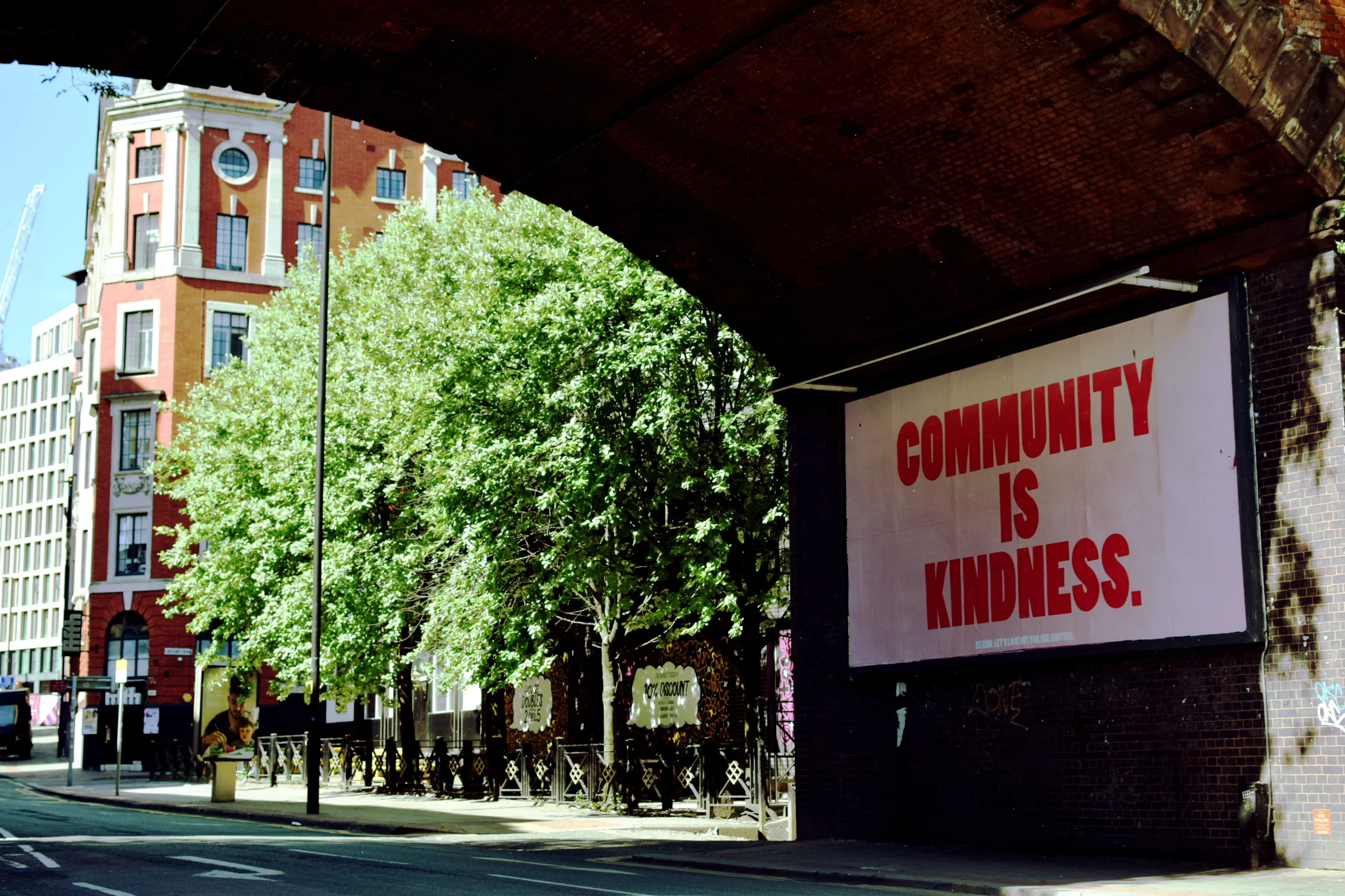 matthew-waring-under Manchester UK bridge a community board -unsplash