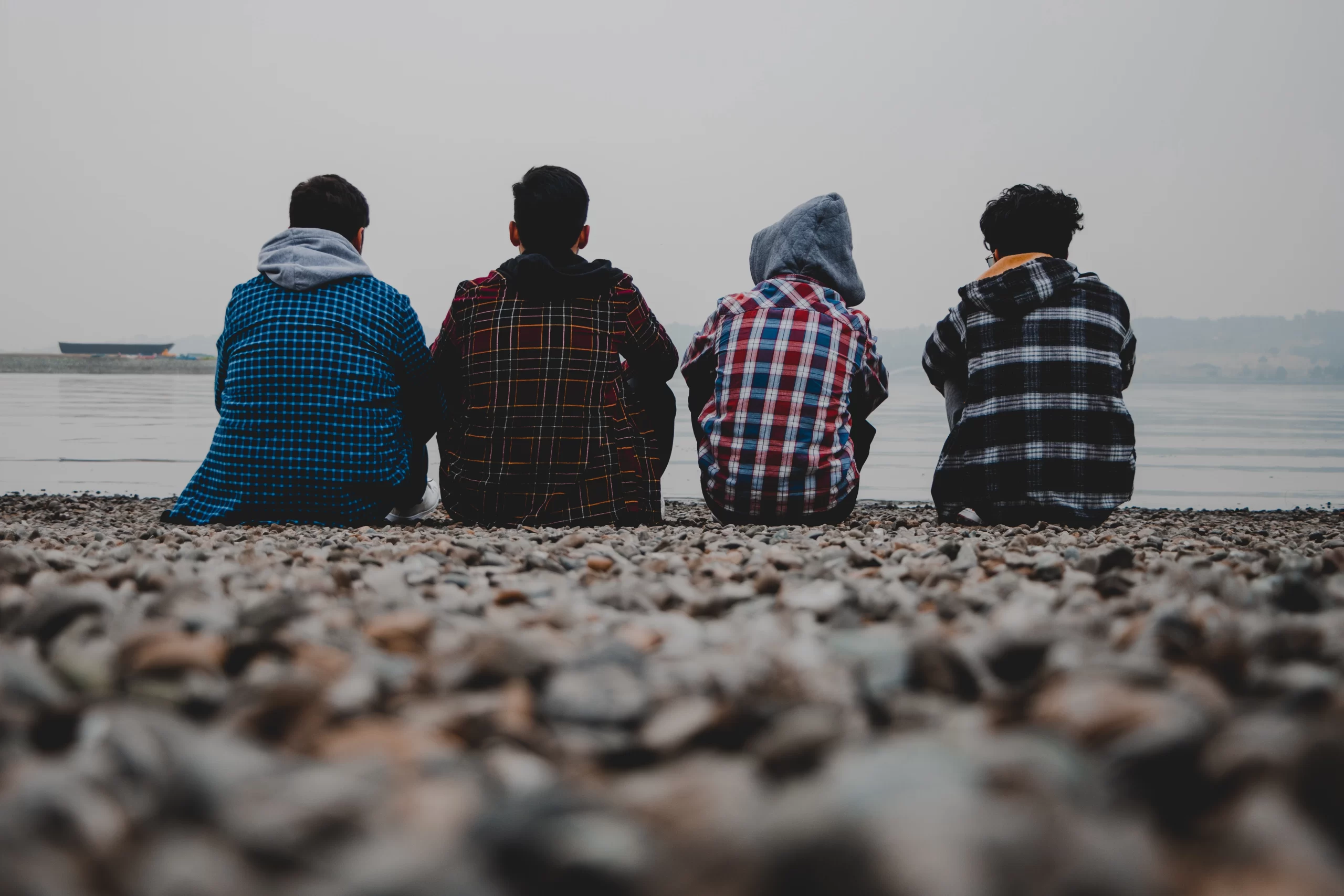 4 Teenage boys sitting on beach with backs to camera Tehran, Tehran Province, Iran<br />
Published on January 10, 2021<br />
Canon, EOS 90D<br />
Free to use under the Unsplash License